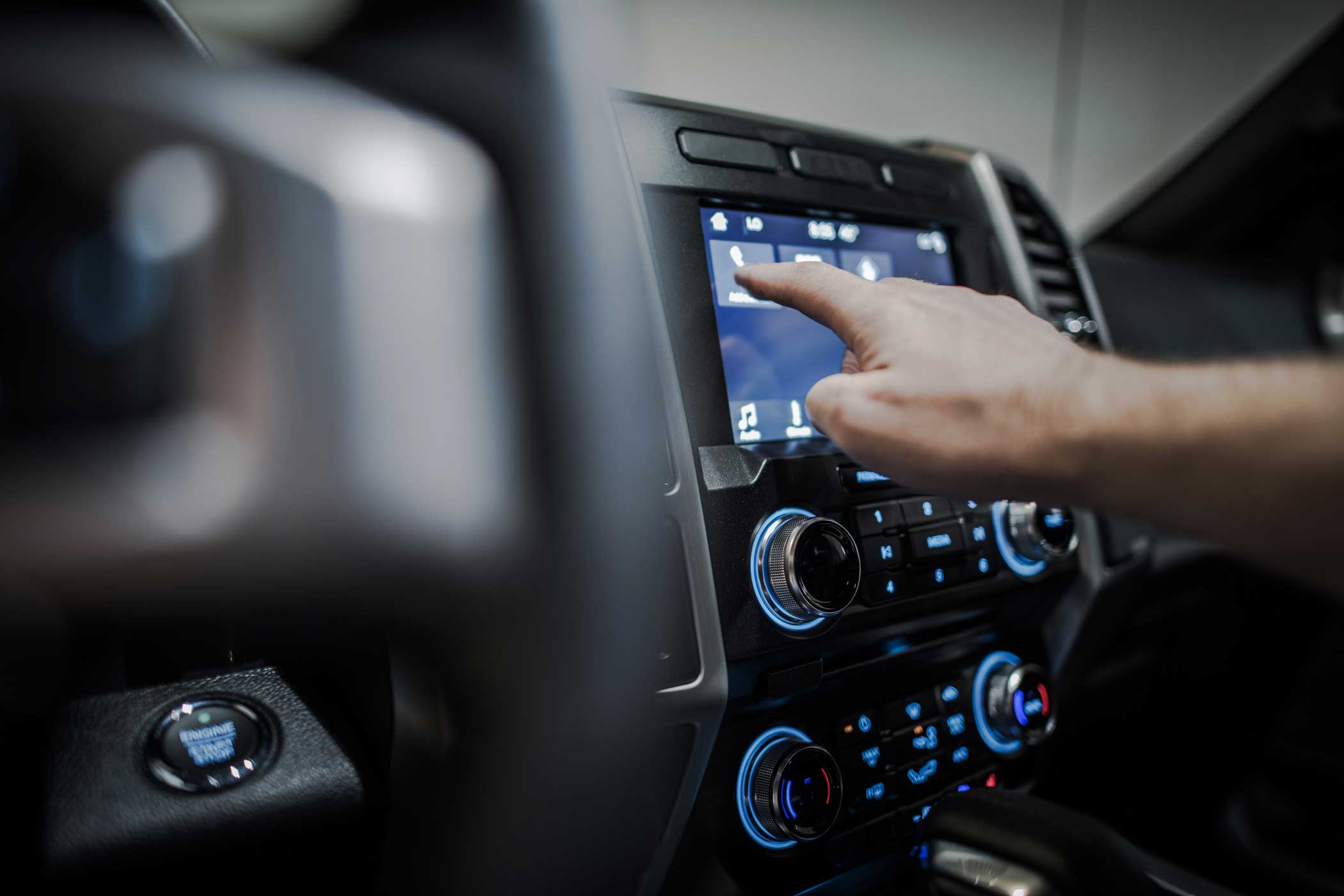 hand interacting with car multimedia system